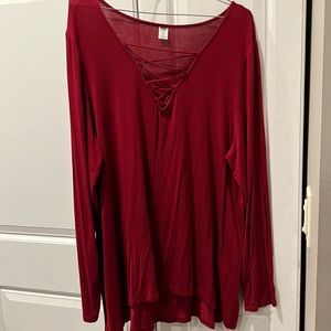 Long sleeve maroon shirt with cross street in the front